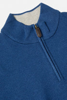 Close-up of the Benetti Quinn Indigo 1/4 Zip knit, showing the indigo ribbed collar and zip pull with contrast inner collar.