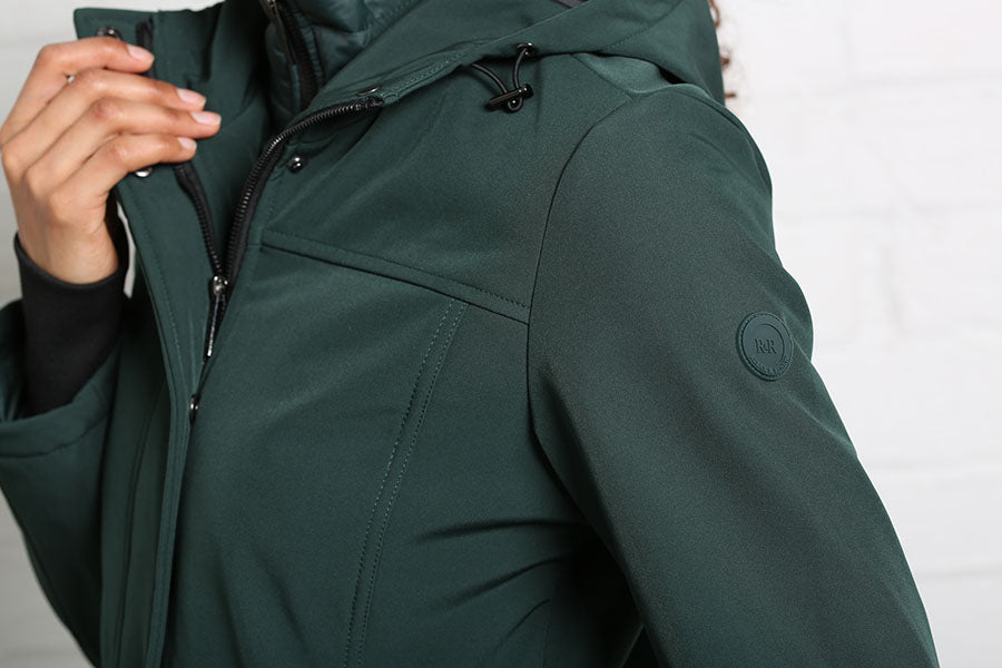 Detail view of the Rant & Rave Relax & Renew Elsie coat in forest showing the hood, shoulder and sleeve logo badge.