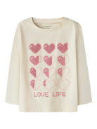 An off-white long-sleeve crewneck sweatshirt featuring a pink pixelated heart pattern and the text 'LOVE LIFE' printed on the front.