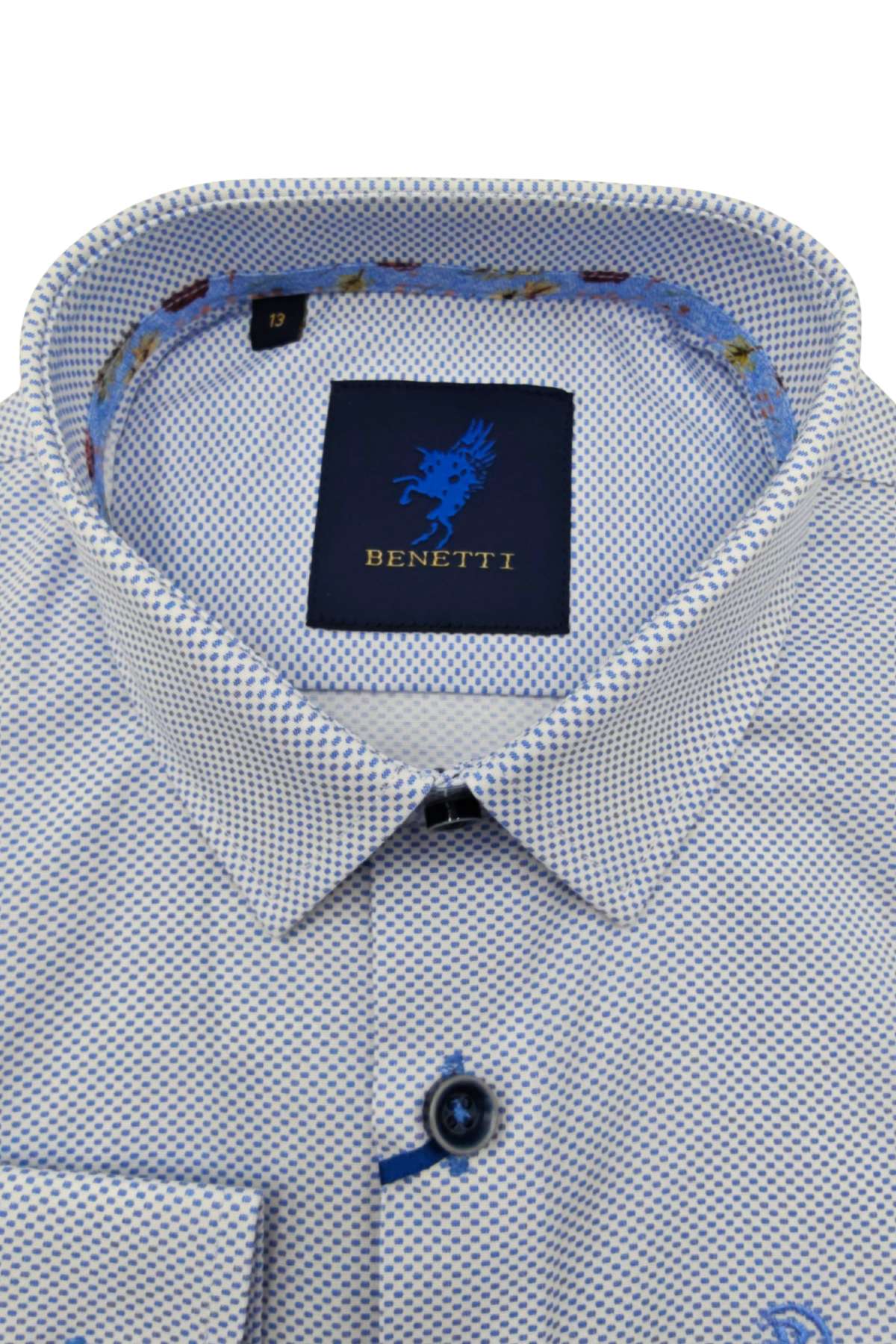 Close-up of a patterned boys shirt collar with a brand label on a white background