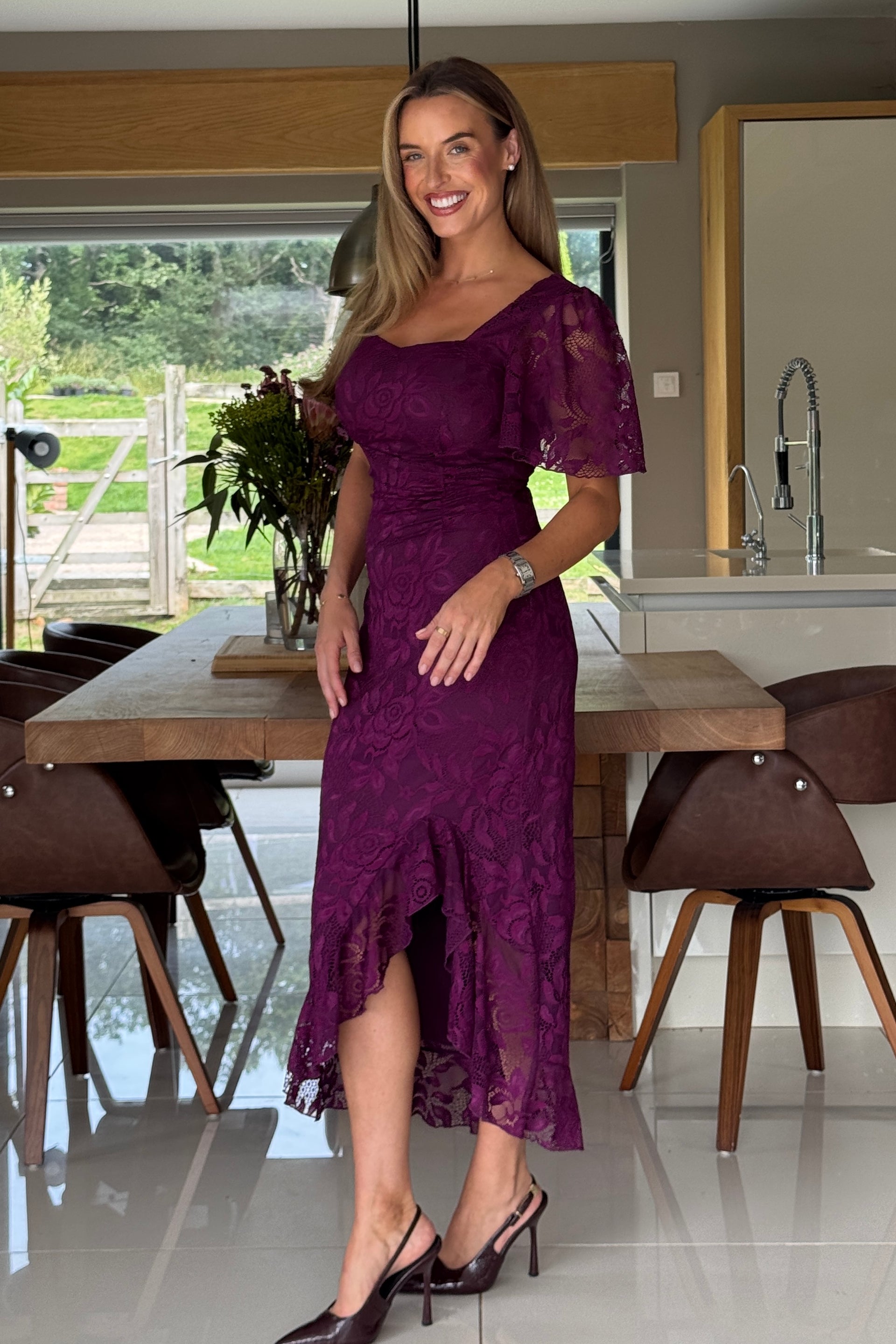 Side view of ruched plum midi dress