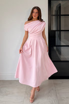 Front view of Betty pink skater midi dress with asymmetric neckline