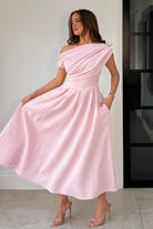 Close-up of asymmetric neckline on Betty pink midi dress