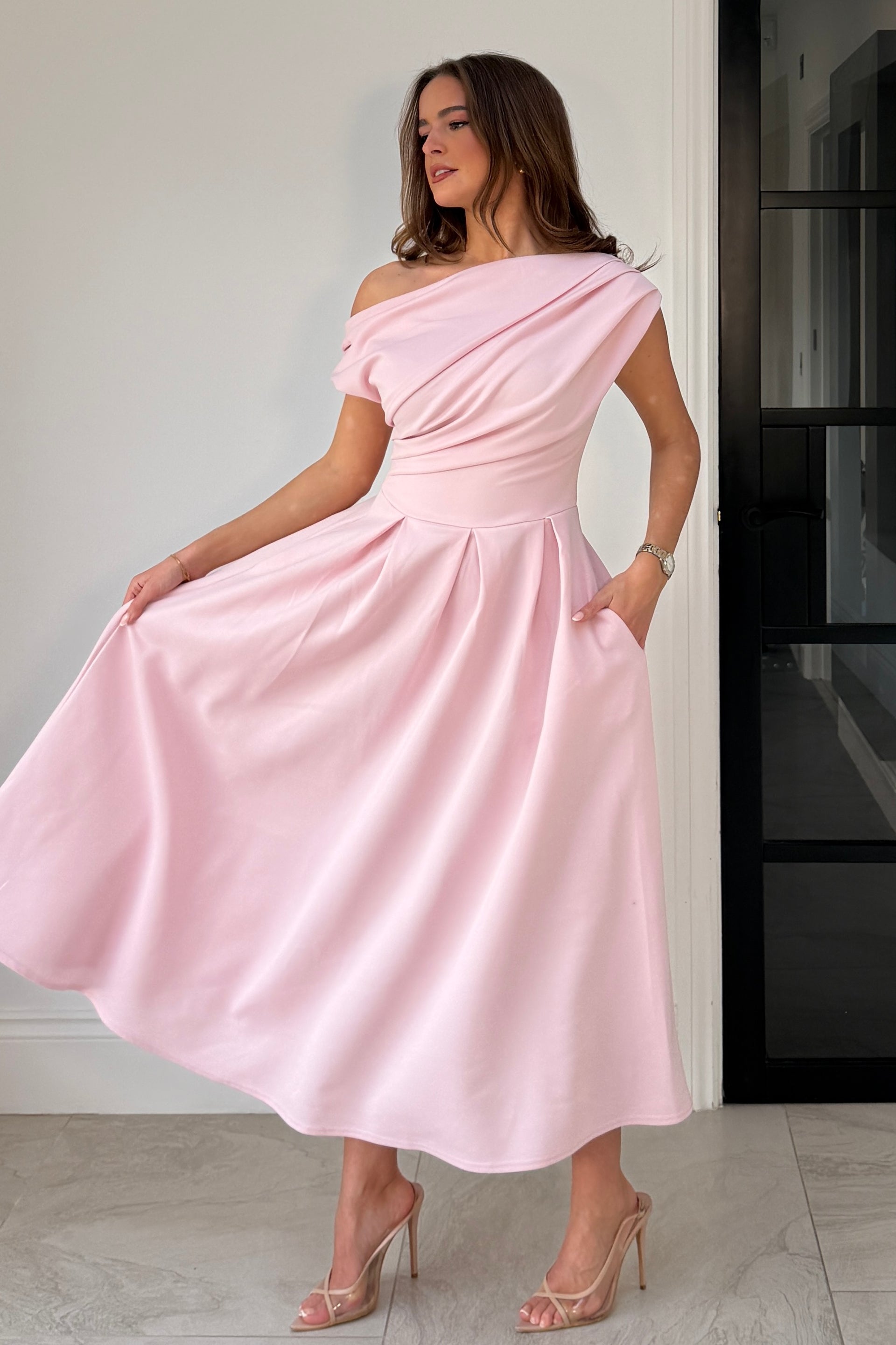 Close-up of asymmetric neckline on Betty pink midi dress