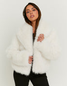 Model wearing the white faux fur jacket from the front