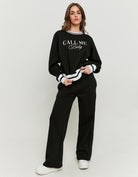 Full-length front view of the black wide leg joggers
