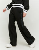 Side view of the black wide leg joggers on model