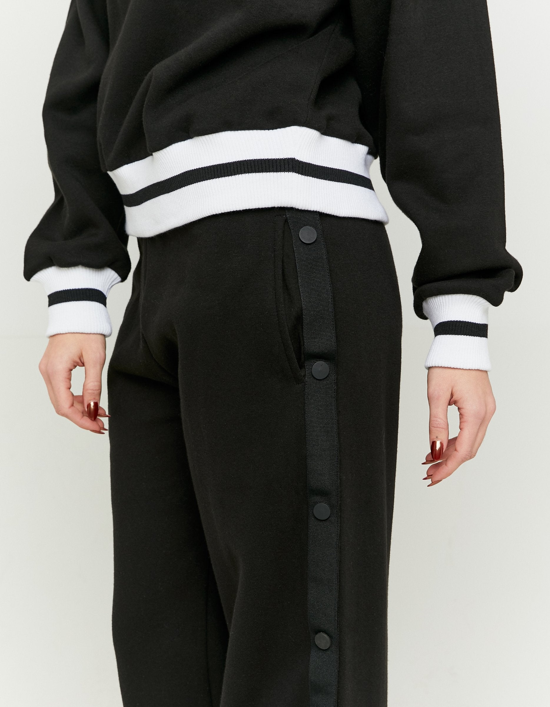 Detail view of the black wide leg joggers side button