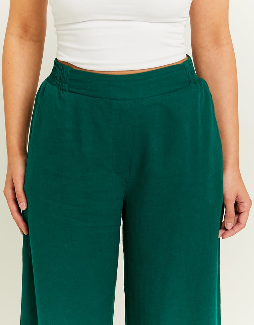 Waist detail of green linen trousers