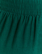 Close-up of green linen fabric trousers
