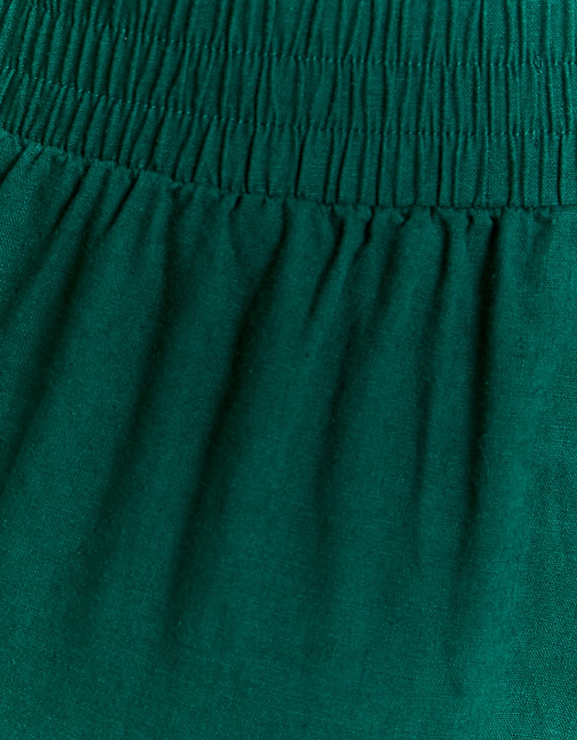 Close-up of green linen fabric trousers