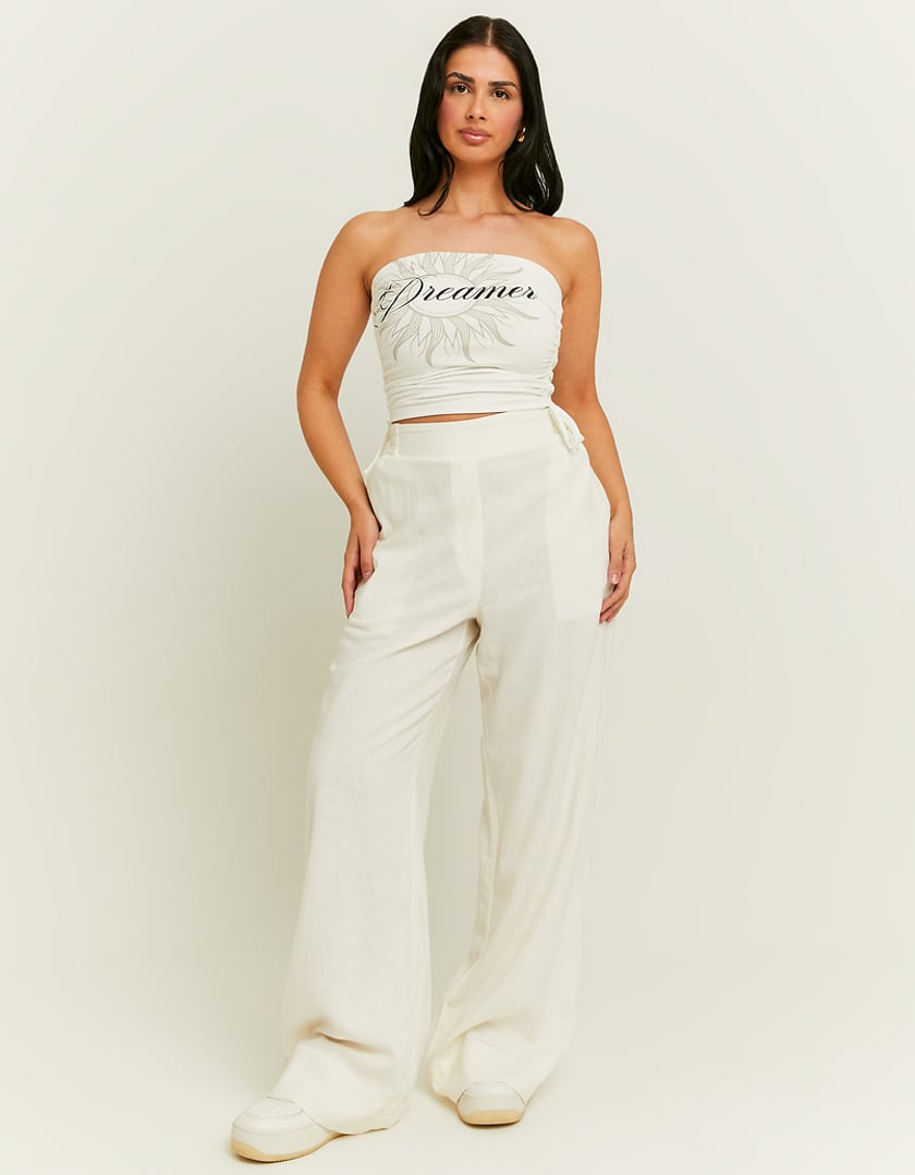 Model wearing the white wide leg linen pants from the front