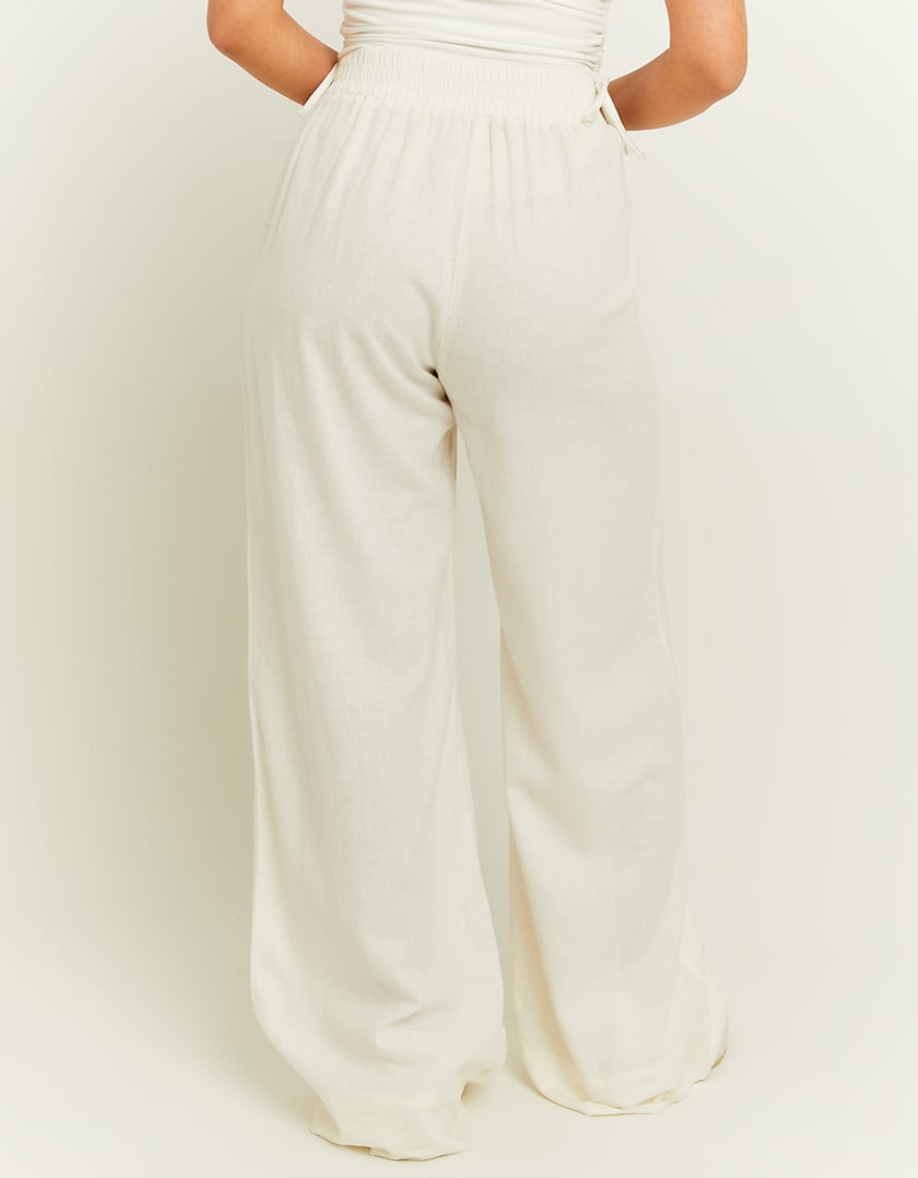 Folded product view of the white wide leg linen pants