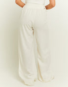 Folded view of the white linen wide leg trousers