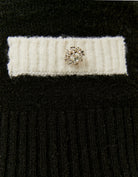Close-up of contrast details on black cropped jumper