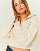 Model side view of white cropped jumper with zip up