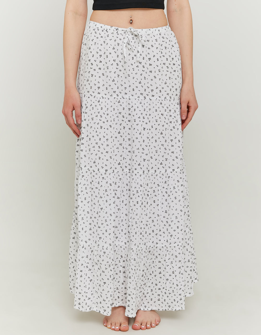 Model front view of long white and black floral skirt