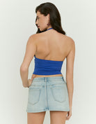 Woman wearing a blue halter top - back view