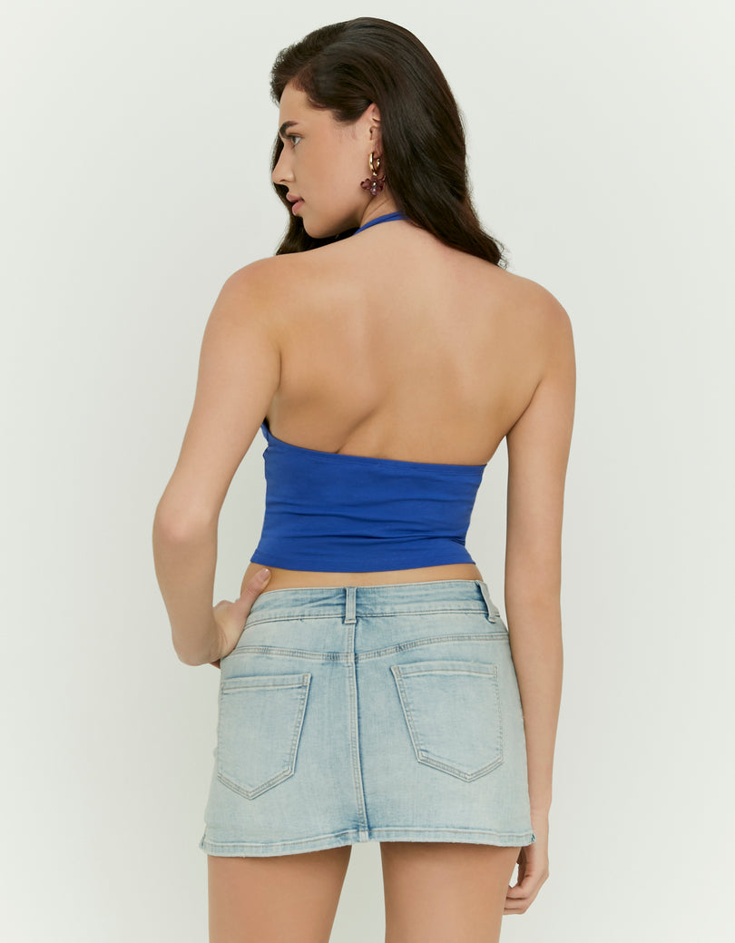Woman wearing a blue halter top - back view
