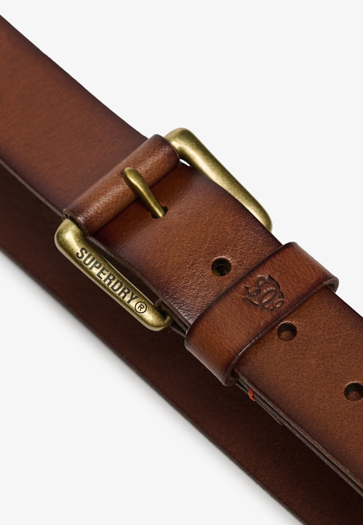 Tan leather belt with brass buckle on a white background