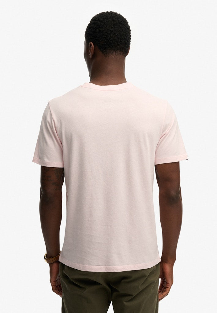 Person wearing a light pink t-shirt on a white background
