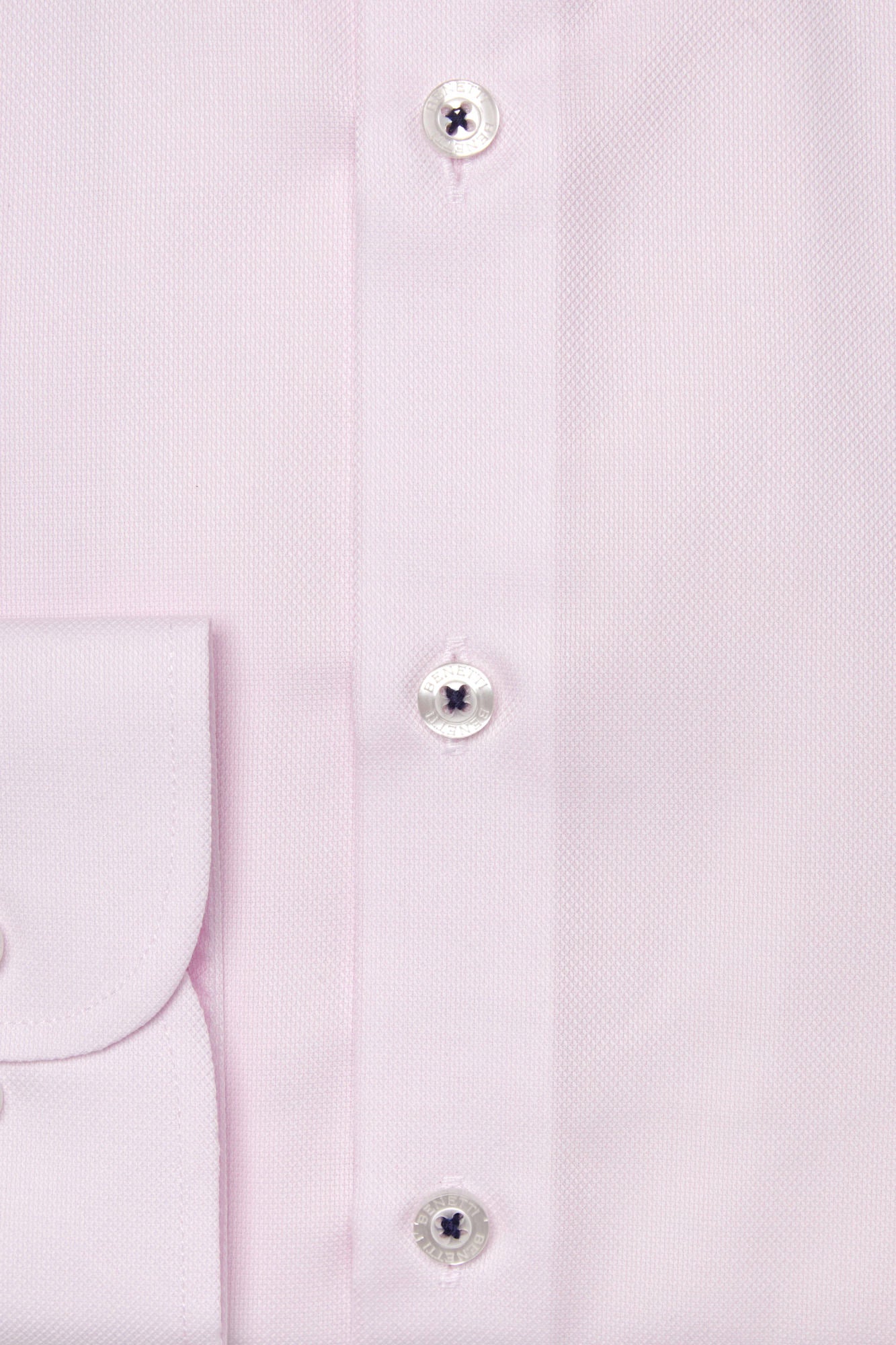 Close-up of a light pink shirt with buttons on a white background