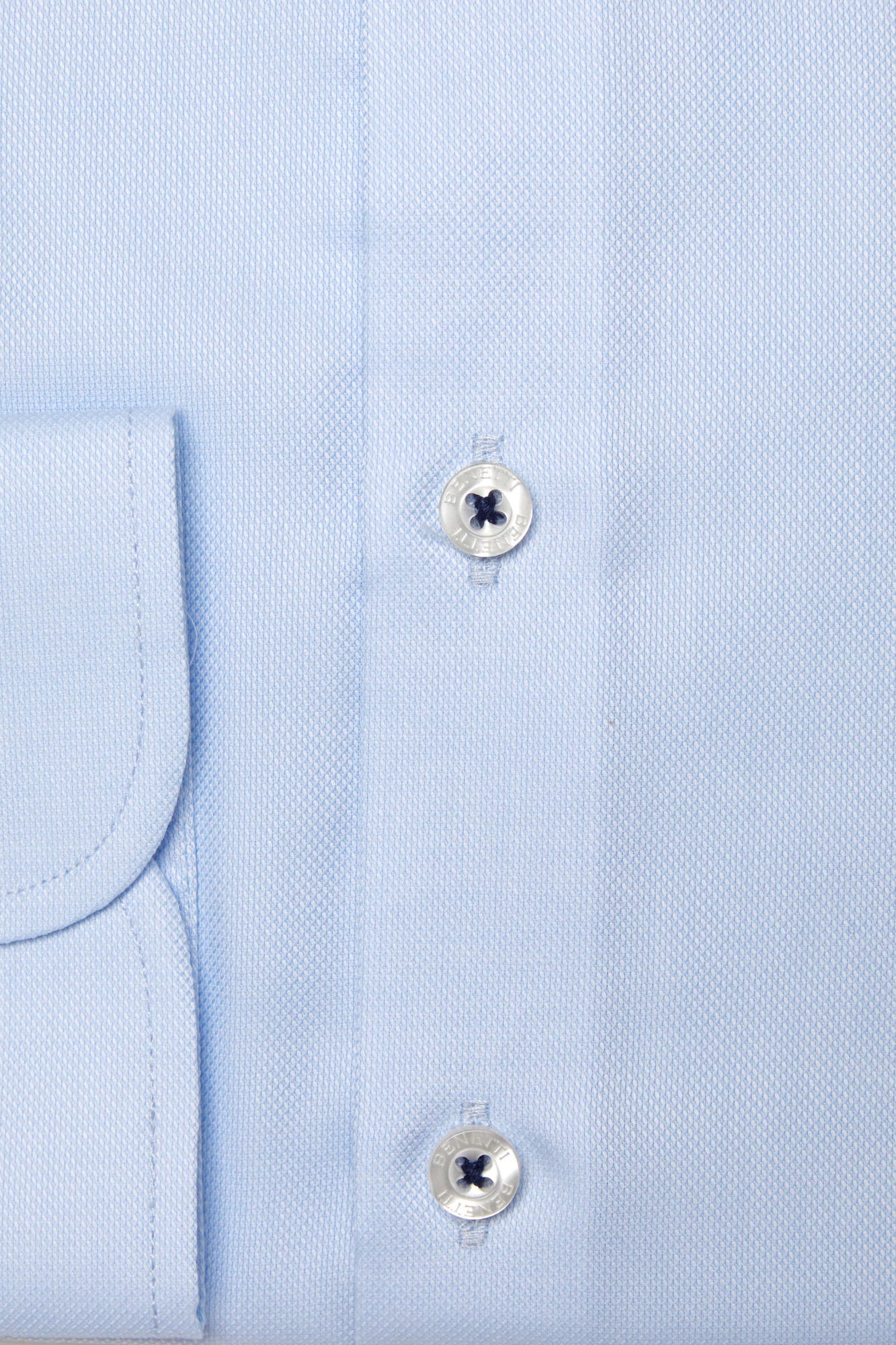Close-up of a light blue dress shirt with buttons