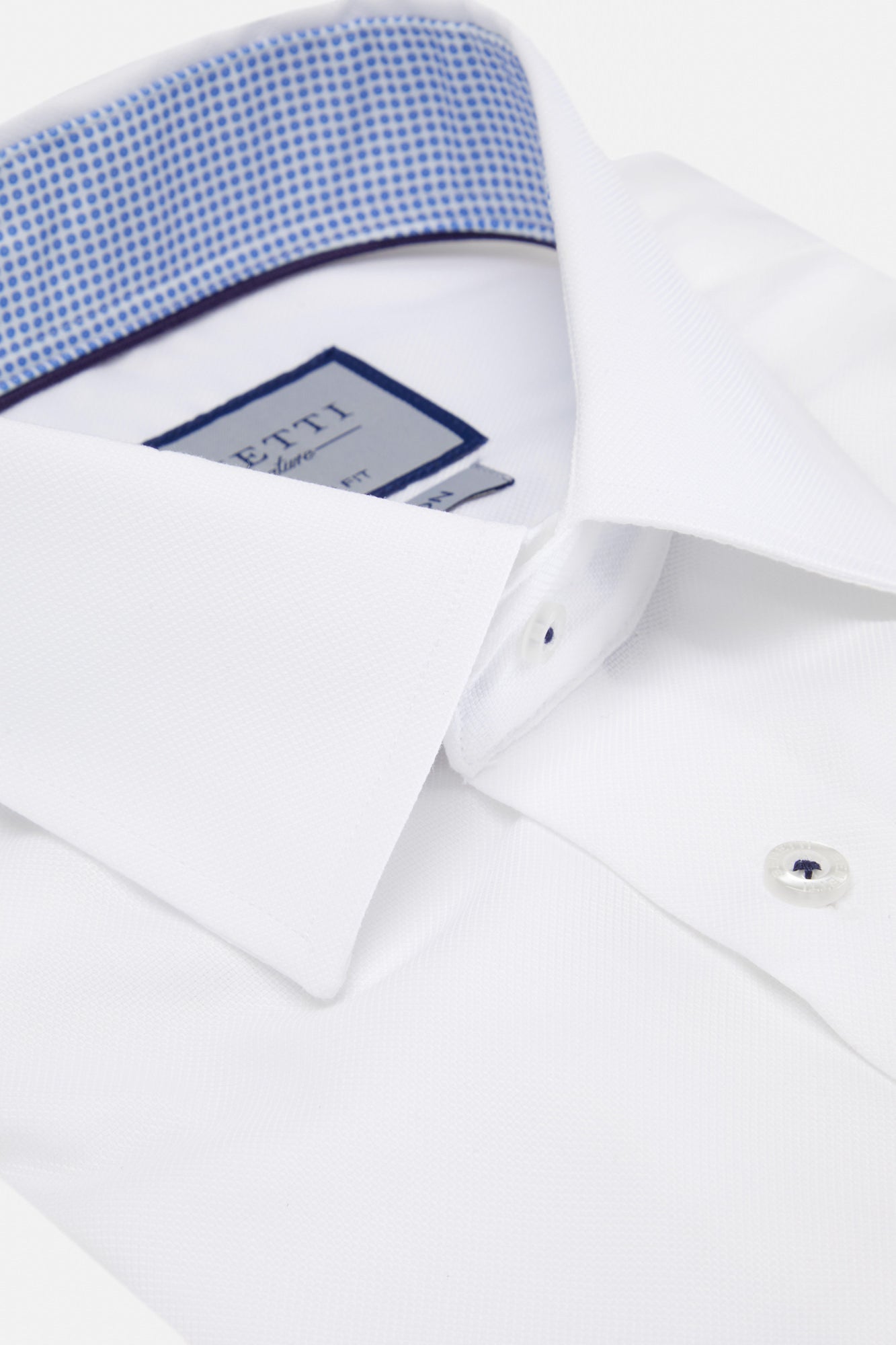 Close-up of a white dress shirt with blue trim and Etro label.