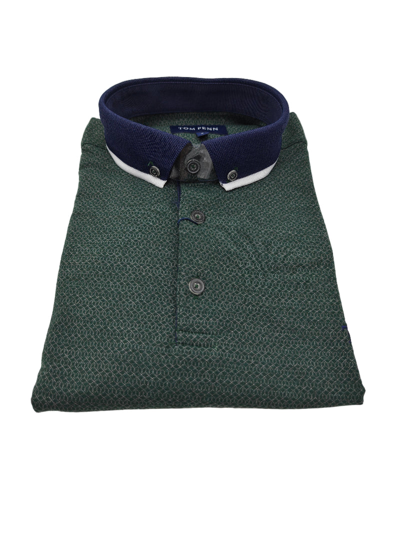 Folded green polo shirt with a dark blue collar on a white background
