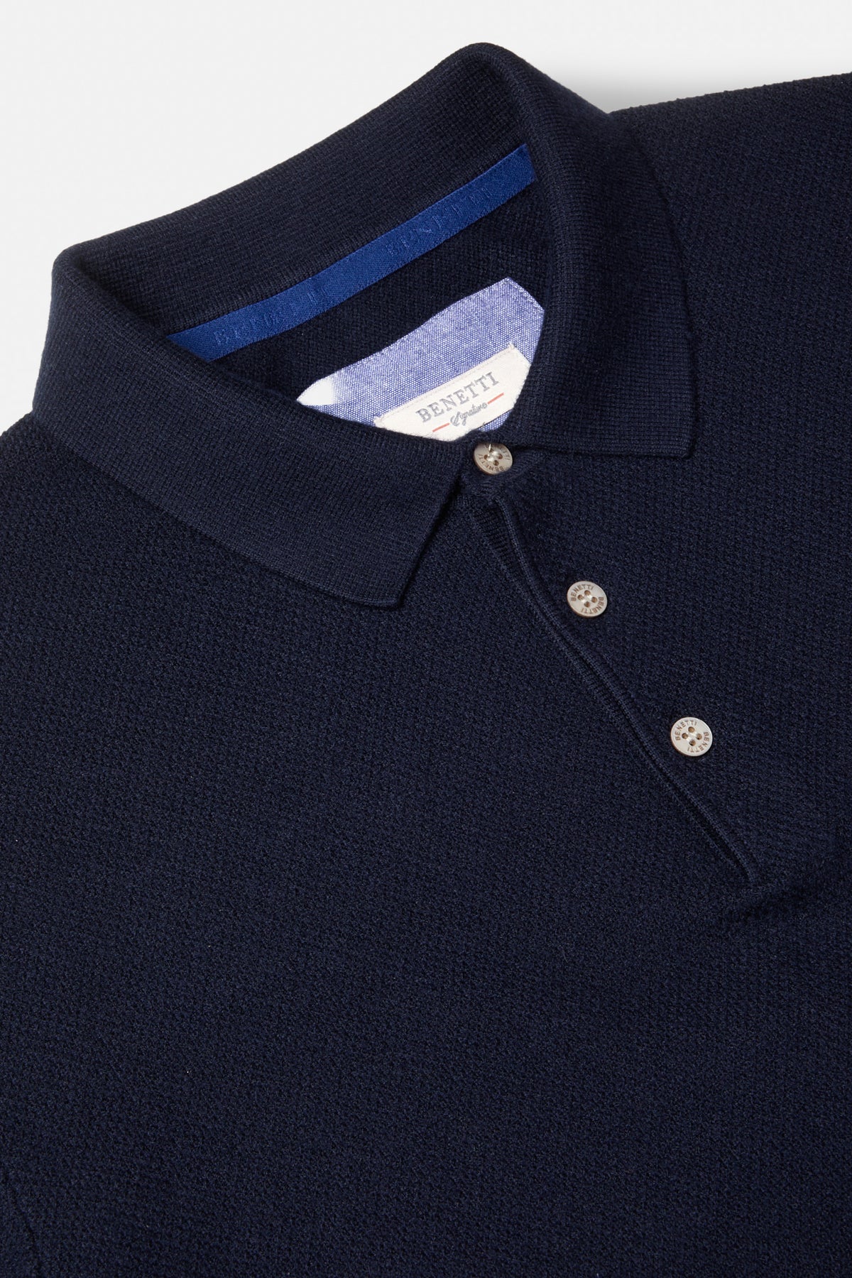 Benetti Trevor Navy Polo, close-up of the collar and button placket on a navy knit polo.