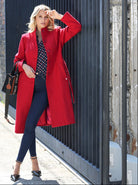 Model styling the Ursla dark indigo skinny jeans with a coat