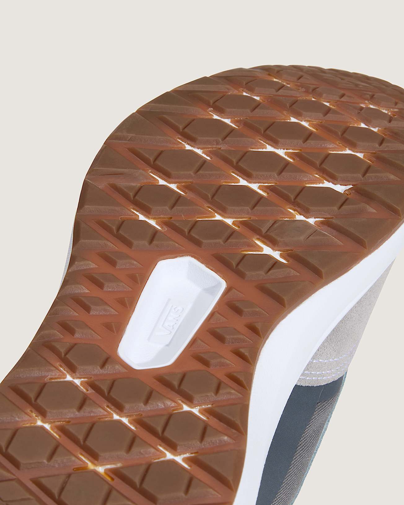 Close-up of a shoe sole with a textured pattern on a light background