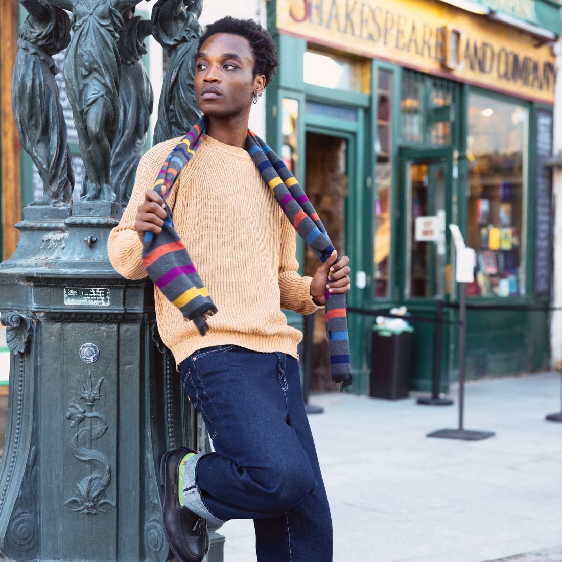 Man wearing a grey/multi stripe bamboo scarf over a beige crew neck jumper
