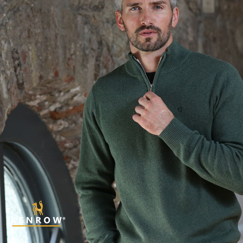 Close up of a man wearing a half-zip sage melange knit