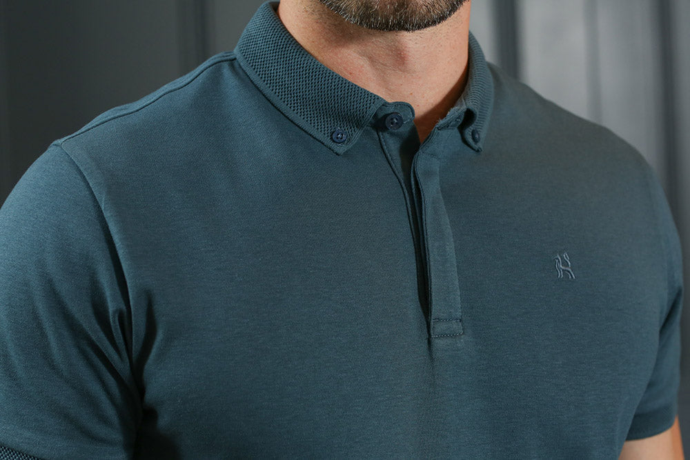 Close - up detail of the Kenrow Vinny Polo Teal collar and embroidered logo