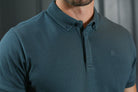 Close - up detail of the Kenrow Vinny Polo Teal collar and embroidered logo