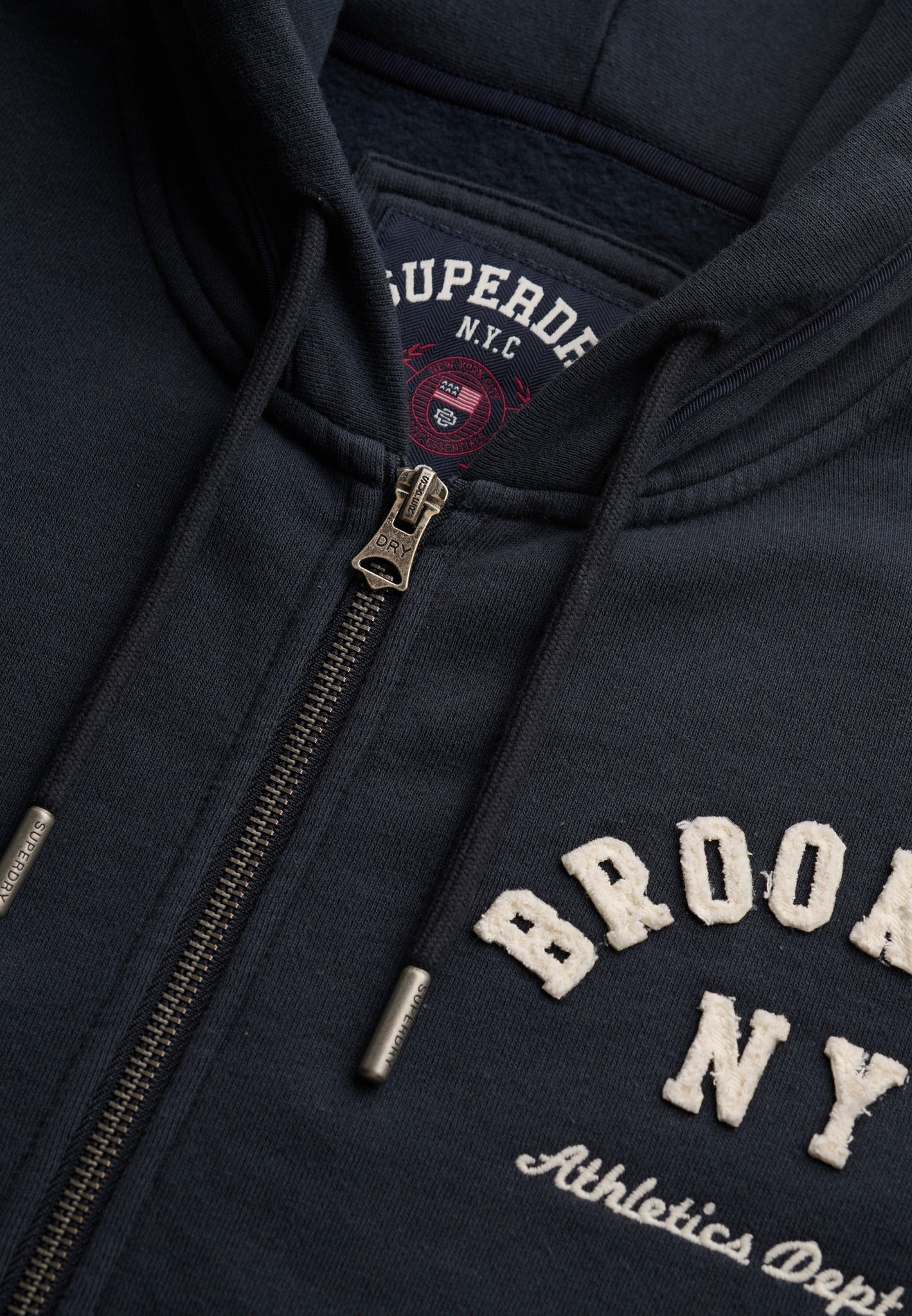 Superdry Ath Essential Relaxed Crop Ziphood in Eclipse Navy zip and logo detail