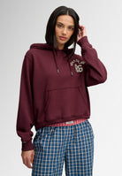 Superdry Ath Essential Applique Crop Hood in Port Red on model