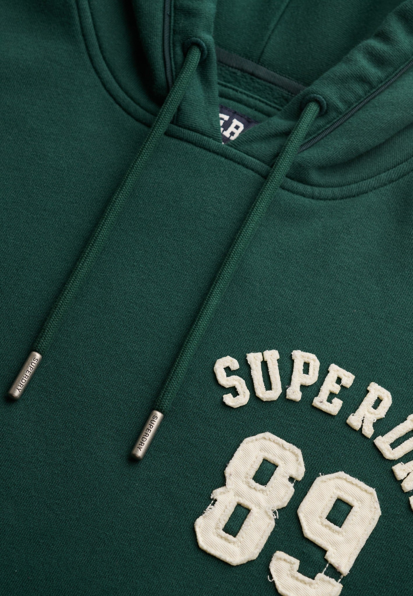 Superdry Ath Essential Applique Crop Hood in Enamel Green applique logo detail