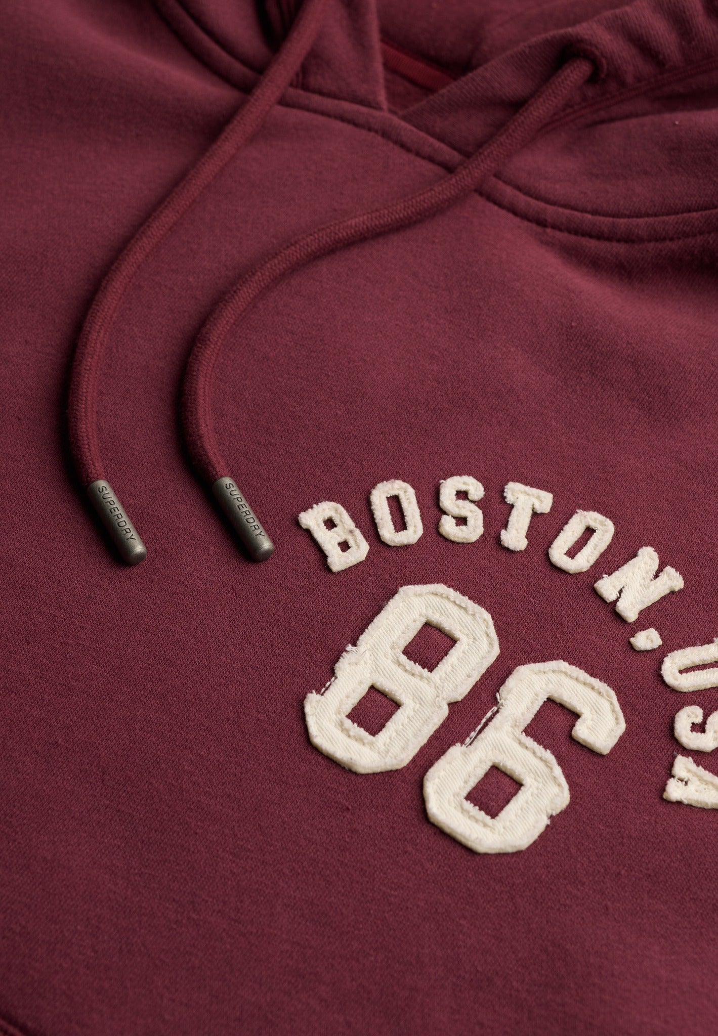 Superdry Ath Essential Applique Crop Hood in Port Red applique logo detail