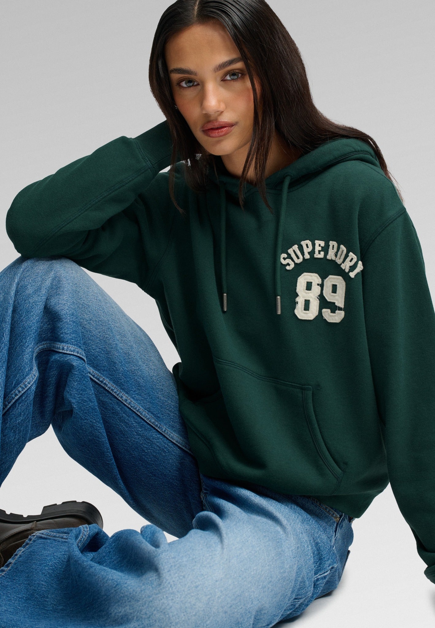 Superdry Ath Essential Applique Crop Hood in Enamel Green seated view