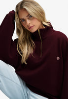 Superdry Monogram Half Zip Sweatshirt in Port Red seated view