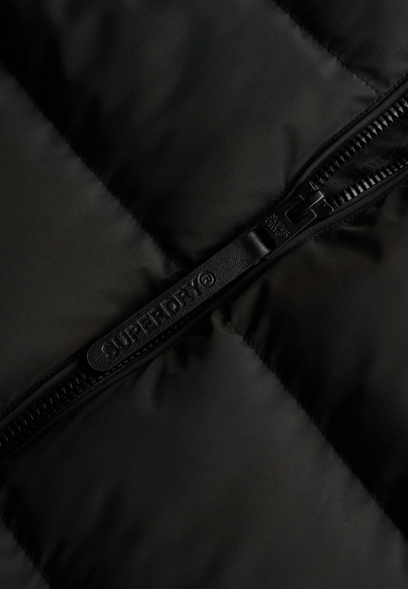 Superdry Hooded Sports Puffer Jacket in Black zip detail angled view