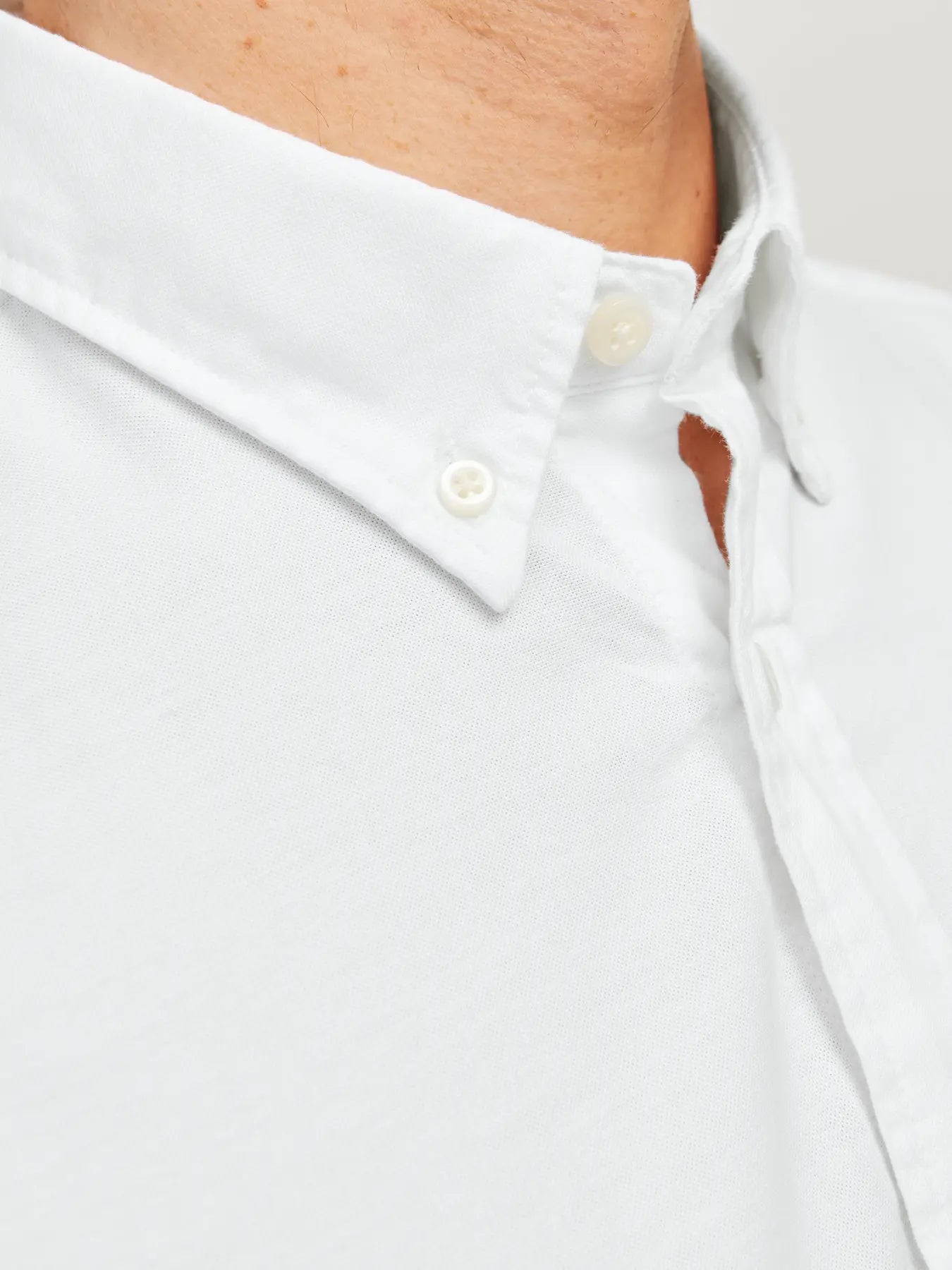 Close-up of a white shirt with buttons