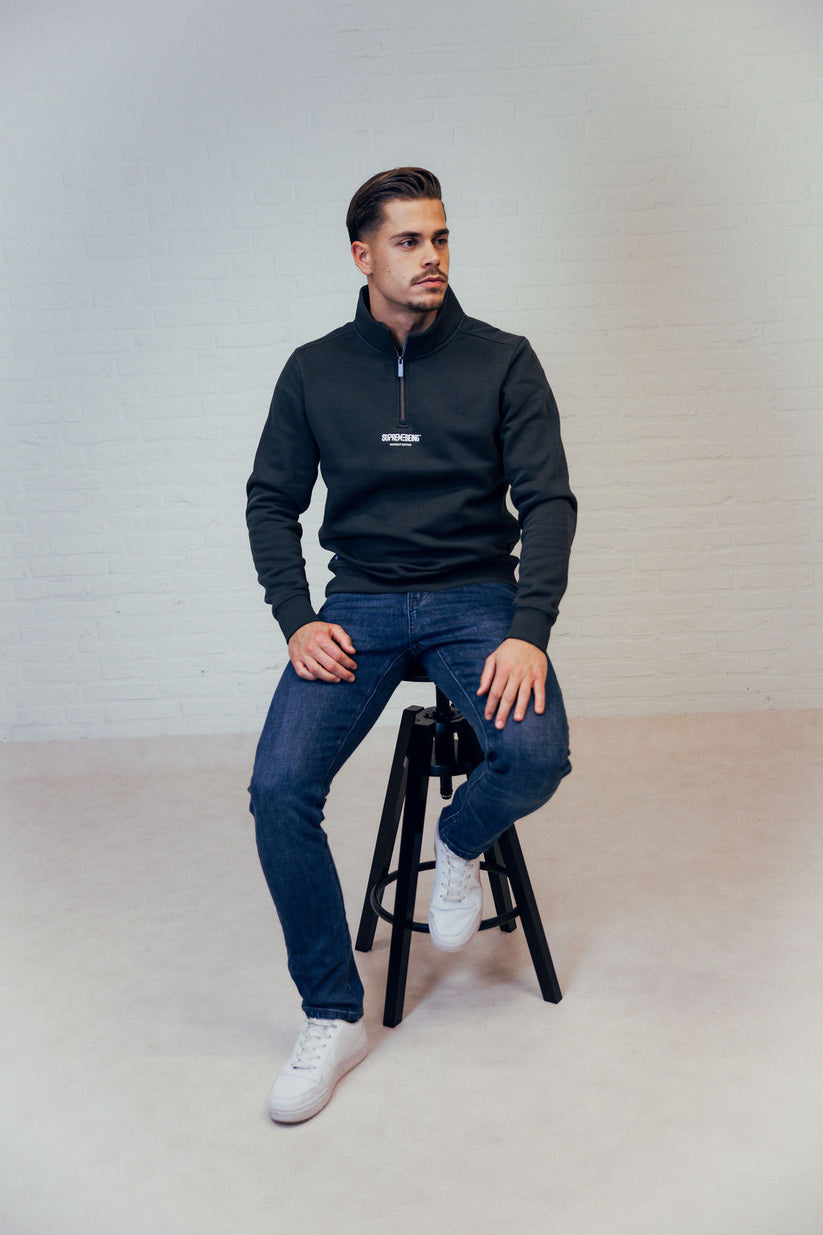 Man wearing a dark green zip up sweatshirt-Looking left