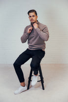Supreme Being Titan quarter-zip sweatshirt in Taupe worn by seated model, front view