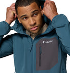 Man wearing a blue Columbia jacket on a white background
