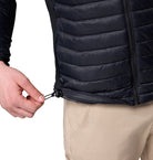 Close-up of a man wearing a black puffer jacket on a white background