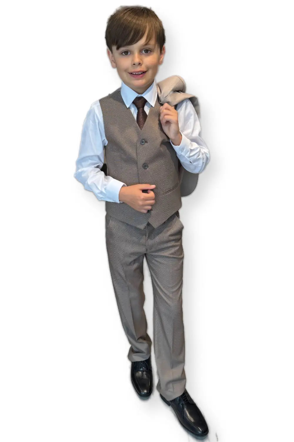 Young boy in a formal suit with a vest and tie on a white background