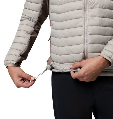 Close-up of a person wearing a light gray puffer jacket with a white background